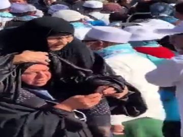 Daughter carrying aged mother